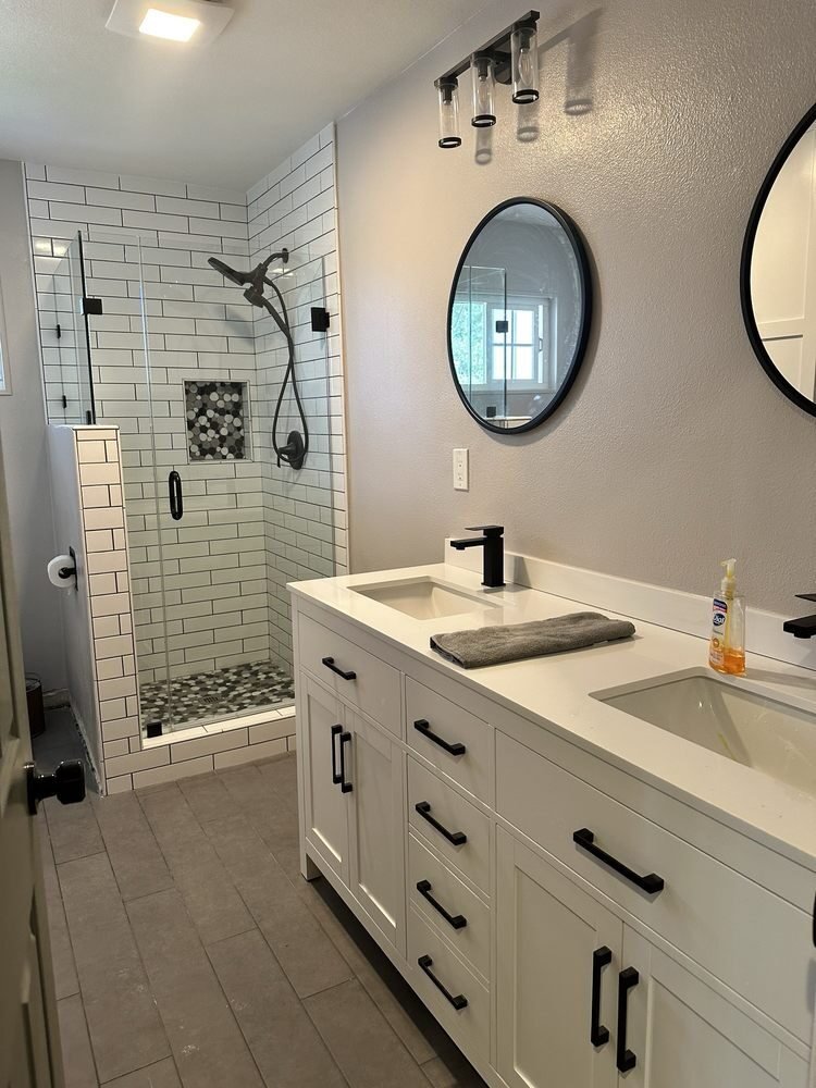 Double-vanity bathroom with subway tile shower installed by JM Custom Tile and Stone in Riverside, CA