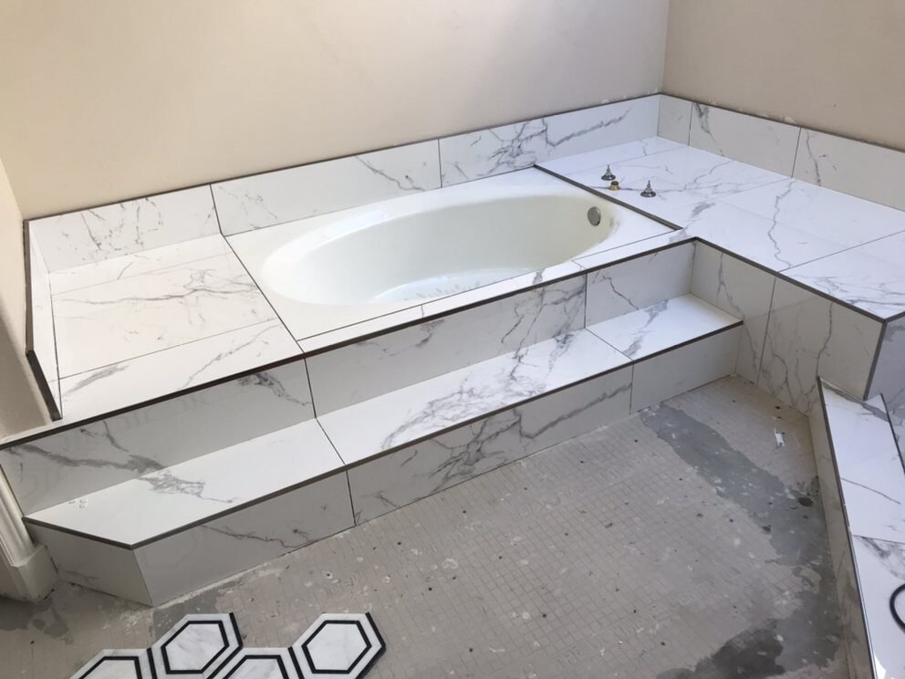Marble tub deck with hexagon accent tile floor installed in Riverside, CA