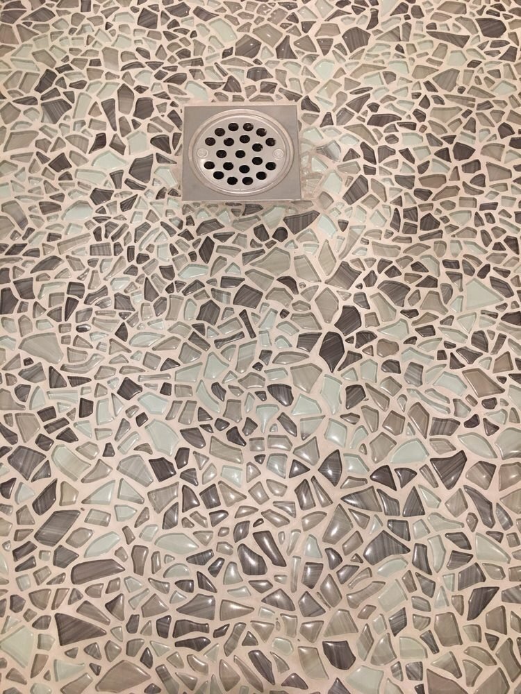 Pebble mosaic shower floor detail from a Riverside bathroom tile installation